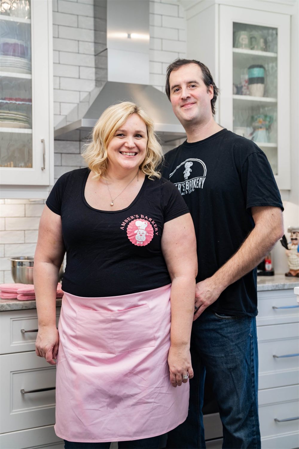 Amber and Steven in matching Amber's Barkery aprons in their kitchen